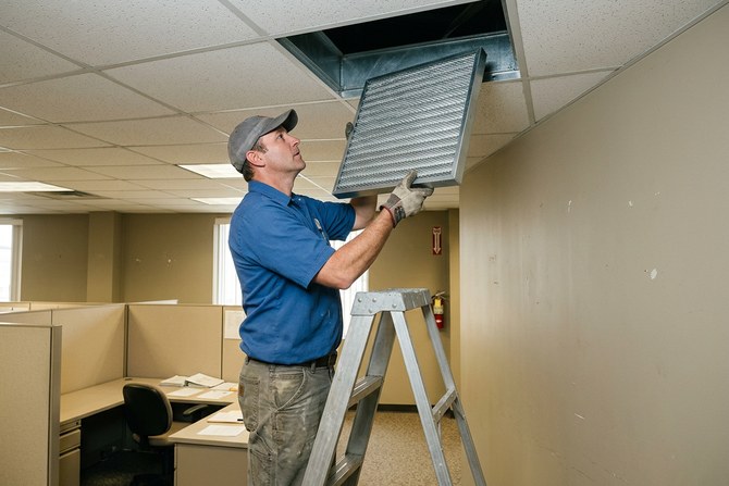 Clean white filter being set into an open ceiling vent